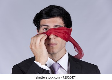 Lost Businessman Peeking Behind A Blindfold