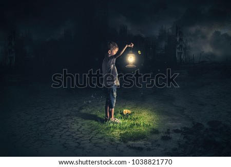 Lost child holding an old lamp in an apocalyptic environment
