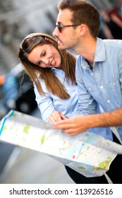 Lost Couple In The City Holding A Map