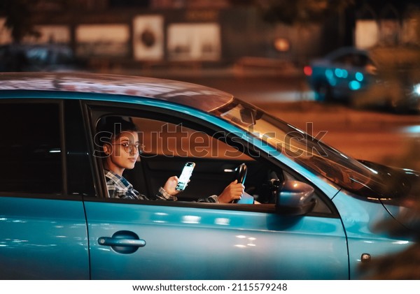 Lost female driver using mobile phone while\
driving at night.