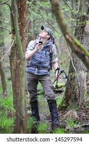 Lost Hiker In Forest With Mobile Satelite Navigation Device  - Geo-caching