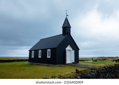 Lost Icelandic church, built in black wood, simple, but at the same time imposing due to its remote location. - Powered by Shutterstock