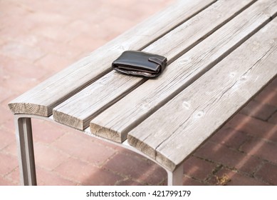 Lost leather wallet on empty bench