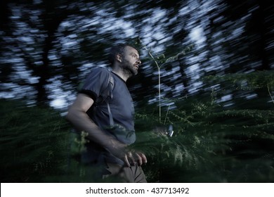 Lost Man Running Through The Woods Trying To Find A Way Out. Orientation, Fear And Survival, Activity In Nature Concept. 
