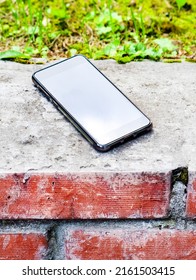 Lost Mobile Phone On The Sidewalk On The Street