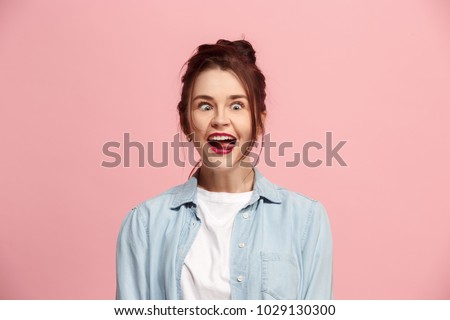 I lost my mind. The squint eyed woman with weird expression. Beautiful female half-length portrait isolated on pink studio backgroud. The crazy woman. The human emotions, april fools day