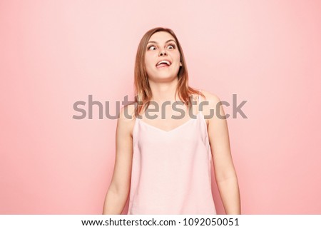 I lost my mind. The squint eyed woman with weird expression. Beautiful female half-length portrait isolated on pink studio backgroud. The crazy woman. The human emotions, facial expression concept.