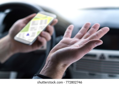 Lost And No GPS Connection. Navigation Problem. Man Using Smartphone Map Application In Car. Clueless And Confused Driver Spreading Hands. Slow Internet Or Bad Signal.