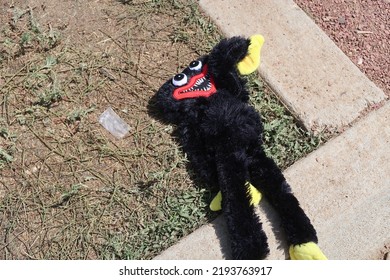 Lost Prize From The County Fair. Creepy Stuffed Animal Laying On The Ground At The Carnival.