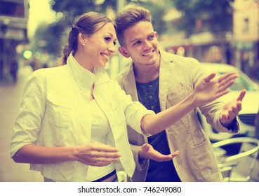 Lost Smiling Woman Asking Stranger At The Street In An Unfamiliar City