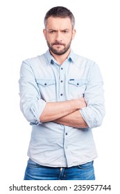 Lost In Thoughts. Worried Young Man In Casual Wear Keeping Arms Crossed And Looking Away While Standing Isolated On White Background