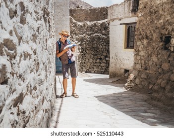 Lost tourist with guide book on unknown asian street - Shutterstock ID 525110443