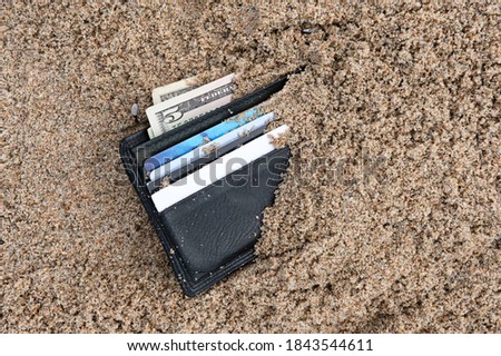 A lost wallet at the beach with cash and credit cards