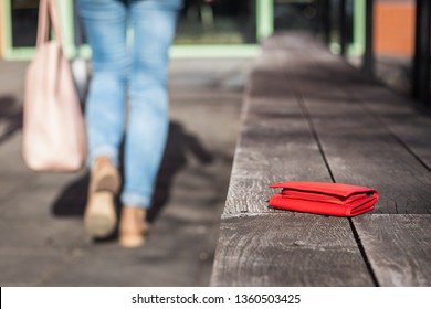 Lost Wallet On City Street. Woman Is Leaving From A Bench Where She Forgot Her Leather Wallet