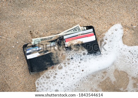 A lost wallet in the surf zone at the beach.
