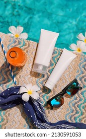 Lotion Cream Set Near Swimming Pool. Face Body Care Summer Beauty Treatment