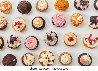 Lots of assorted colorful cupcakes from above with toppings and decorations for a birthday - Powered by Shutterstock