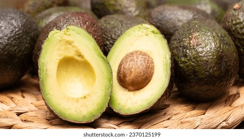 Lots of avocados and cut avocados - Shutterstock ID 2370125199