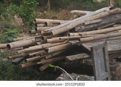 lots of bamboo stacked in piles, bamboo cut into long pieces - Powered by Shutterstock