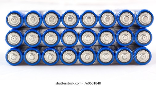 Lots Of Blue Batteries, Type AA, Packed In Polyethylene Film, On A White Background, Macro
