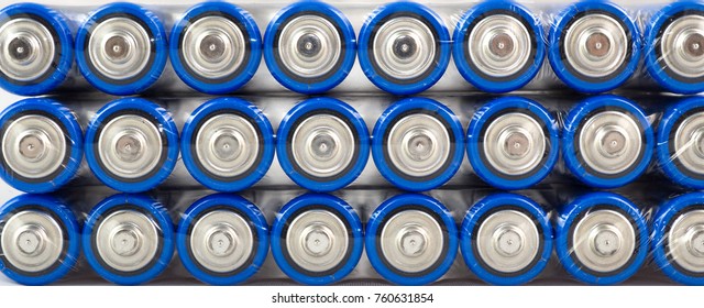 Lots Of Blue Batteries, Type AA, Packed In Polyethylene Film, On A White Background, Macro
