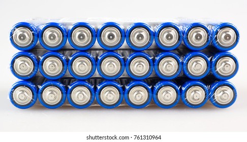 Lots Of Blue Batteries, Type AA, Packed In Polyethylene Film, On A White Background, Macro
