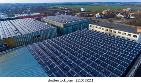 Lots Of Blue Photovoltaic Solar Panels On The Top Of The Building. Flat Roof Densely Covered With Solar Batteries. View From The Above.