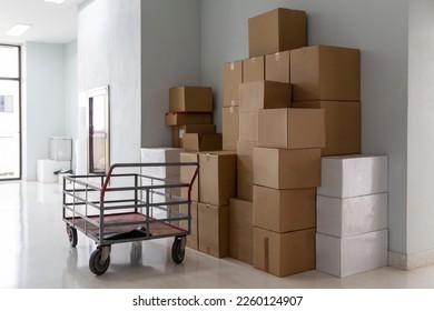 Lots of boxes placed inside the building. Stocking goods for export. Building without people.