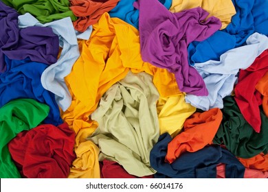 Lots of bright messy colorful clothing, abstract background.