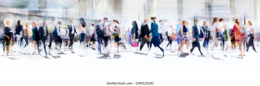 Lots of business people walking in the City of London. Blurred image, wide panoramic view of the road with people at sunny day. London, UK