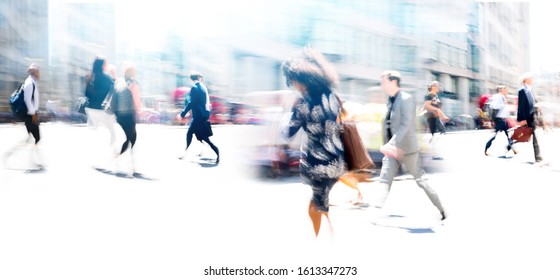 Lots of business people walking in the City of London. Blurred image, wide panoramic view of the crossroad with people at sunny day. London, UK - Shutterstock ID 1613347273