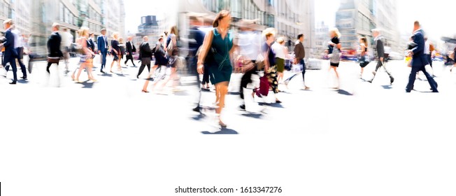 Lots of business people walking in the City of London. Blurred image, wide panoramic view of the crossroad with people at sunny day. London, UK - Shutterstock ID 1613347276