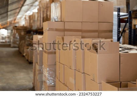 Lots of cardboard boxes in fulfillment center. Indoor view of warehouse.