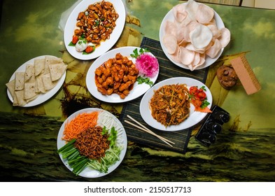 Lots Of Chinese Food On The Table. Chicken In Sweet And Sour Sauce, Chicken Fillet With Peanuts, Peking Pork, Rice Noodles With Seafood.