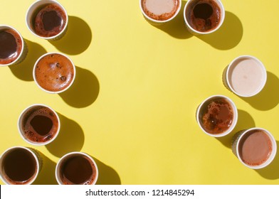 Lots of coffee cups with different types of coffee, cappuccino and macchiatoon on blue background with blank space for text. Top view, lat lay.