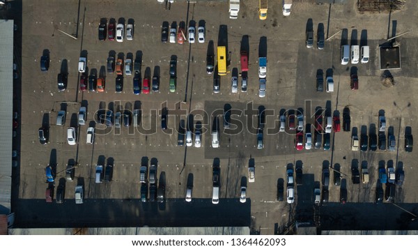 Lots of colorful cars in the parking lot.\
Vertical car photography from a\
height.