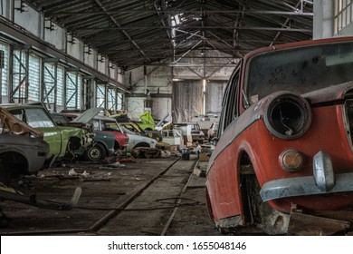 Lots Of Colorful Old Cars In A Hall Of An Abandoned Car Repair Shop