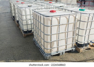 Lots cube water tanks  1000 litres containers piled outdoors