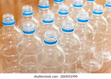 Lots of empty plastic bottles on the wooden flooring