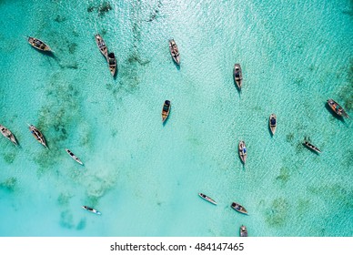 lots of fishing boats in clear turquoise ocean near Africa, top view