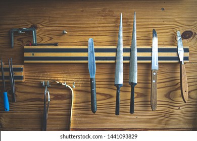 Lots Of Hand Tools Hanging On The Magnetic Hanger With Woodden Wall Of Craftman Workshop Show The Elegent And Detailing Work Of Carpenter, Guitar, Strings,violin Luthier