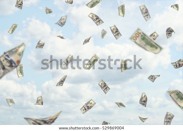 Lots of hundred dollars banknotes\
falling from the blue cloudy sky. Sudden changes in income. Make\
profits. Business development. Rise in\
profitability.