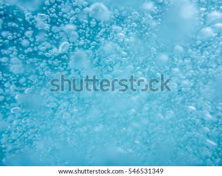 Lots of light Air Bubbles in clear blue Water