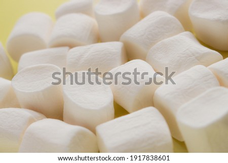 a lots of marshmallows in the yellow background