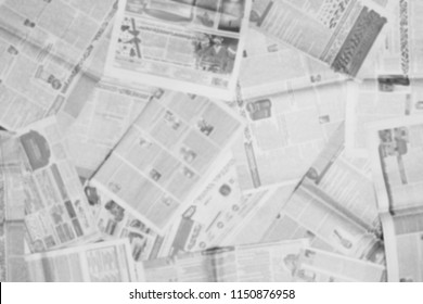 Lots of old newspapers on horizontal surface. Background texture, top view, blurred                                     