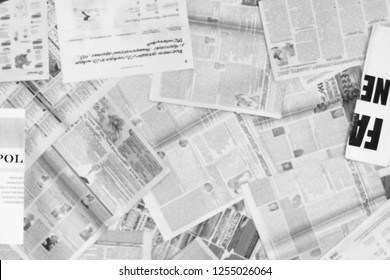 Lots of old newspapers on horizontal surface. Background texture, top view, blurred                      