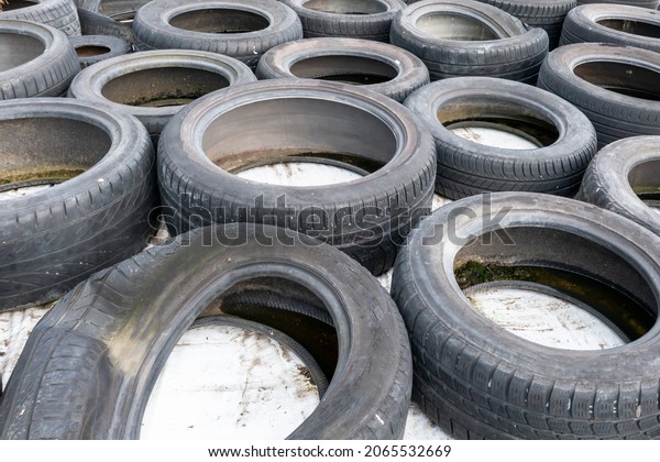 Lots\
of old used car tires close up on white\
background
