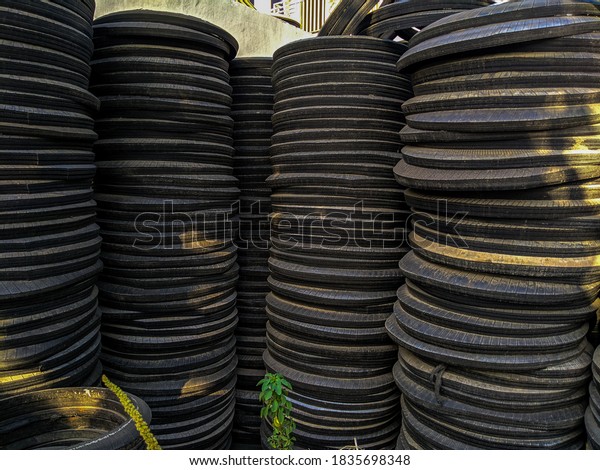 lots of piles\
of used car tires near the\
housing