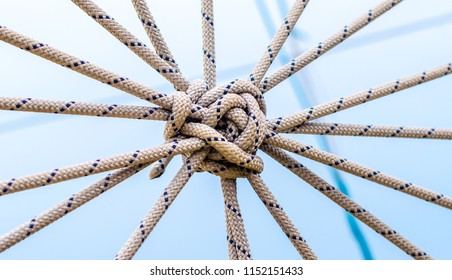 lots of ropes and a big knot against the blue sky - Shutterstock ID 1152151433