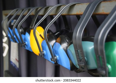 Lots Of Sports Shooting Headphones Hang On A Hanger At The Range. Ear Protection.